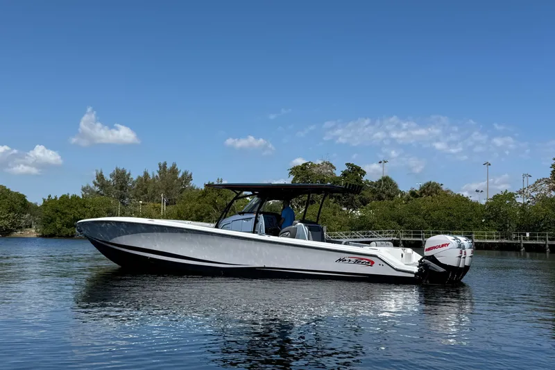  Yacht Photos Pics 2018 Nor-Tech 390 Sport Center Console boat on calm water under clear blue sky.