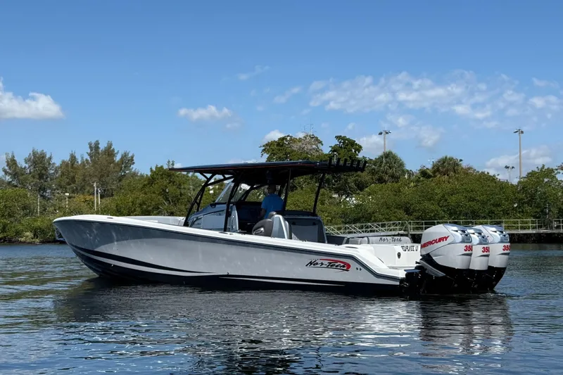 Yacht Photos Pics 2018 Nor-Tech 390 Sport Center Console boat on calm water, featuring triple Mercury engines.