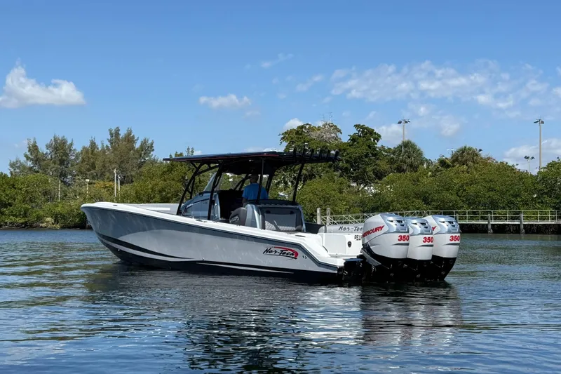  Yacht Photos Pics 2018 Nor-Tech 390 Sport Center Console boat with triple Mercury engines on calm water.