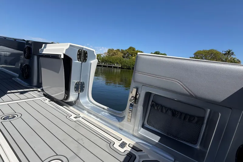  Yacht Photos Pics 2018 Nor-Tech 390 Sport Center Console boat interior with open side door, docked by water.