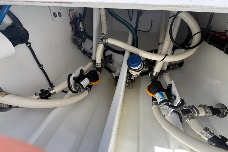  Yacht Photos Pics Engine compartment of a 2018 Nor-Tech 390 Sport Center Console with visible hoses and fittings.