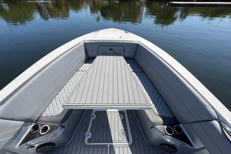  Yacht Photos Pics 2018 Nor-Tech 390 Sport Center Console boat interior with sleek seating and table on calm water.