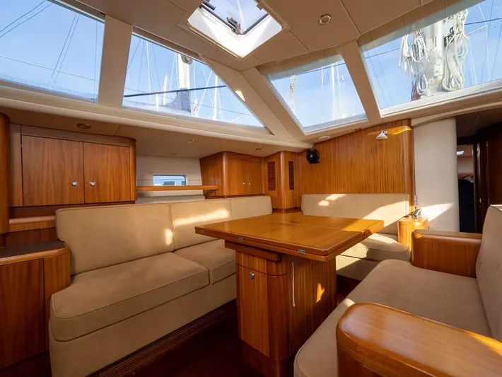 Gulliver Yacht Photos Pics Luxurious interior of 2009 Najad 570 yacht with wooden furnishings and skylights.