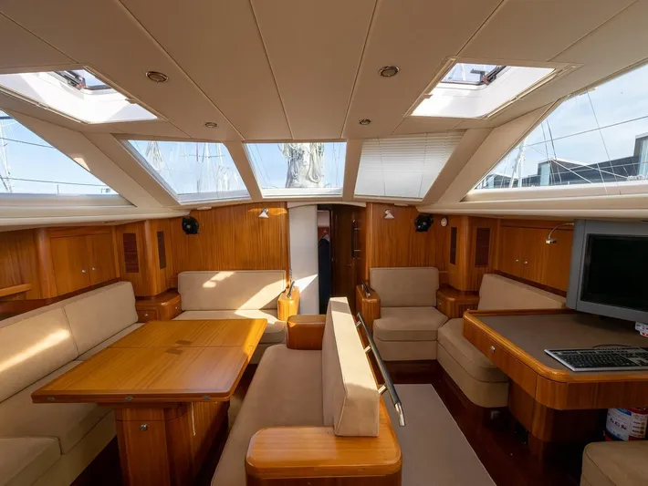 Gulliver Yacht Photos Pics Luxurious interior of 2009 Najad 570 yacht with wooden furnishings and skylights.