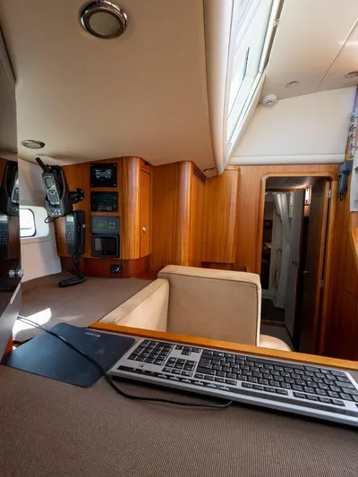 Gulliver Yacht Photos Pics Interior of 2009 Najad 570 yacht with wooden paneling and navigation equipment.