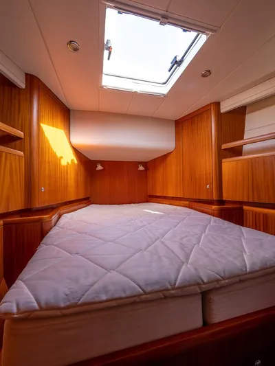 Gulliver Yacht Photos Pics Luxurious cabin interior of 2009 Najad 570 yacht with wooden finish and skylight.