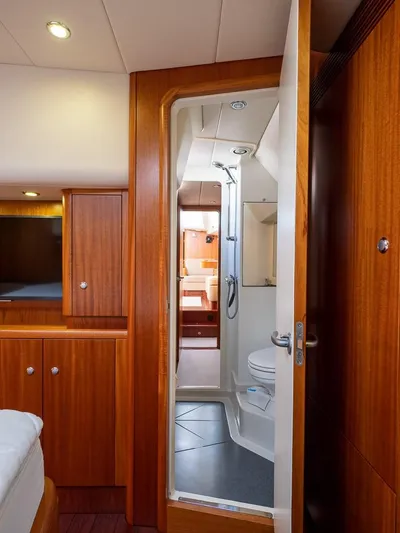 Gulliver Yacht Photos Pics Luxurious 2009 Najad 570 yacht interior with wooden cabinetry and modern bathroom.