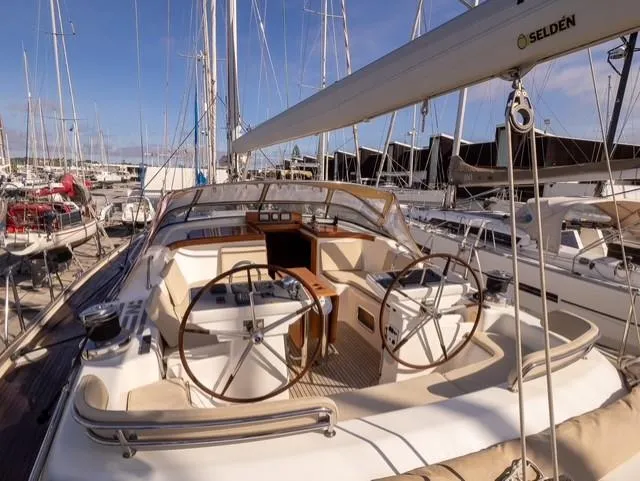 Gulliver Yacht Photos Pics 2009 Najad 570 yacht with dual steering wheels docked in a marina.