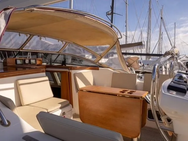 Gulliver Yacht Photos Pics Luxurious 2009 Najad 570 yacht interior with elegant seating and wooden table.