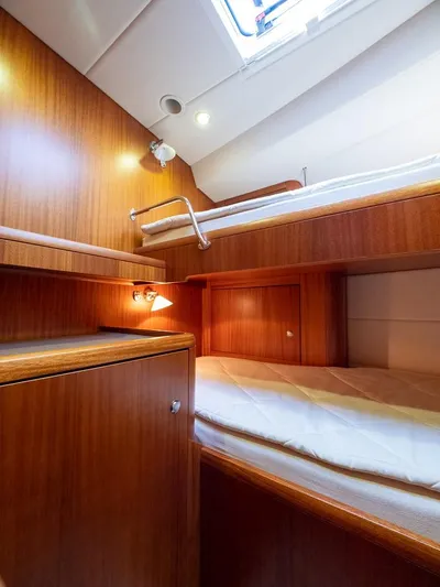 Gulliver Yacht Photos Pics Interior of 2009 Najad 570 yacht with wooden bunk beds and soft lighting.