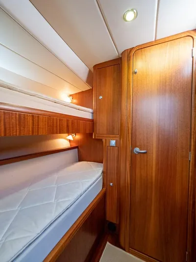 Gulliver Yacht Photos Pics 2009 Najad 570 yacht interior with wooden bunk beds and door.