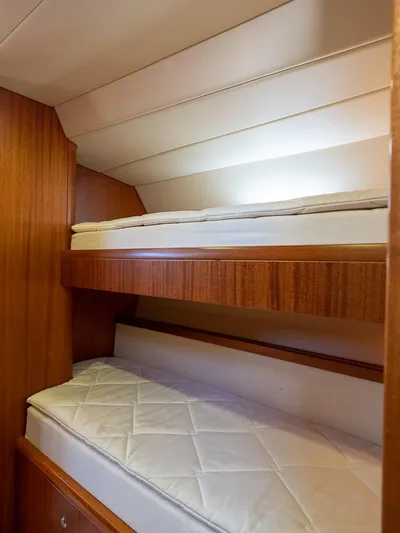 Gulliver Yacht Photos Pics Interior of 2009 Najad 570 yacht with wooden bunk beds and white mattresses.