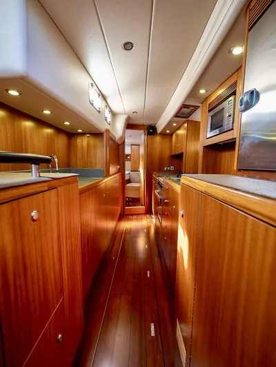 Gulliver Yacht Photos Pics Luxurious 2009 Najad 570 yacht interior with wooden cabinetry and modern kitchen amenities.