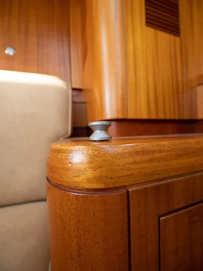 Gulliver Yacht Photos Pics Wooden interior detail of 2009 Najad 570 yacht, featuring elegant cabinetry and metal knob.