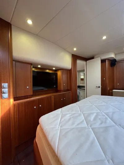 Gulliver Yacht Photos Pics Luxurious interior of 2009 Najad 570 yacht with wood cabinetry and cozy bedding.