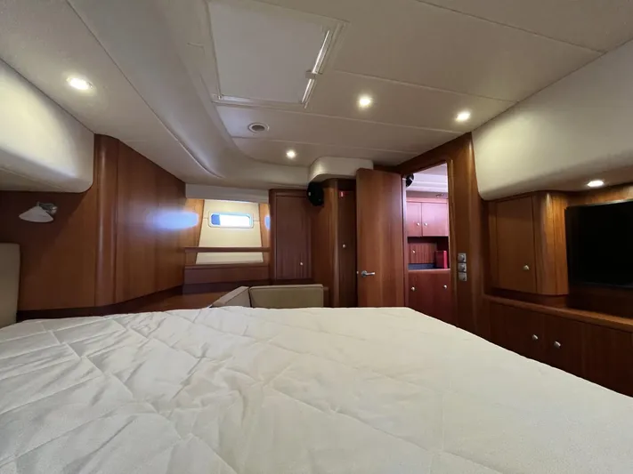 Gulliver Yacht Photos Pics Luxurious cabin interior of 2009 Najad 570 yacht with wood paneling and cozy lighting.