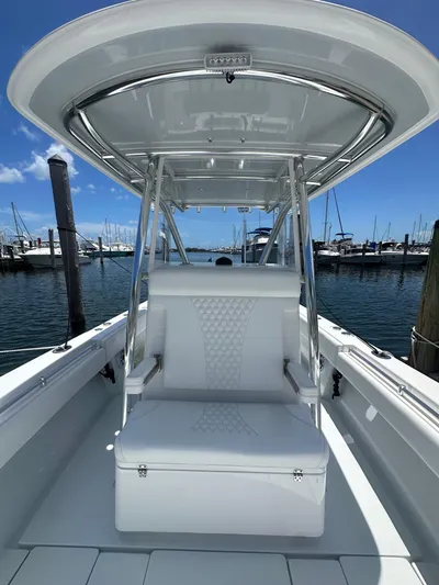  Yacht Photos Pics 2025 Contender 30 T boat with sleek seating, docked at a marina under clear blue skies.