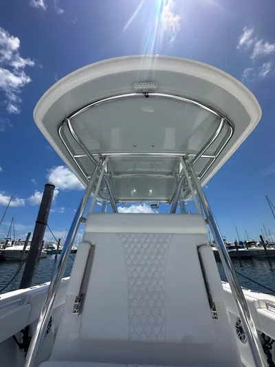  Yacht Photos Pics 2025 Contender 30 T boat with sleek design under clear blue sky.