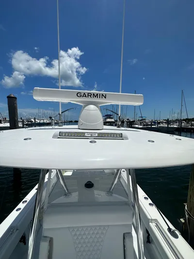  Yacht Photos Pics 2025 Contender 30 T boat with Garmin radar, docked at marina under clear blue sky.