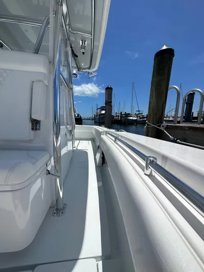  Yacht Photos Pics 2025 Contender 30 T boat docked at marina under clear blue sky.
