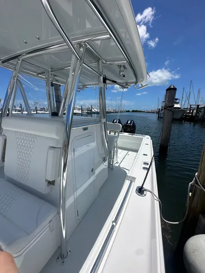  Yacht Photos Pics 2025 Contender 30 T boat docked at marina under clear blue sky.