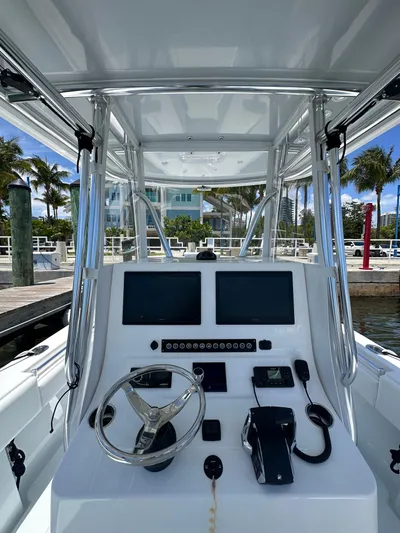  Yacht Photos Pics 2025 Contender 30 T boat dashboard with dual screens and steering wheel.