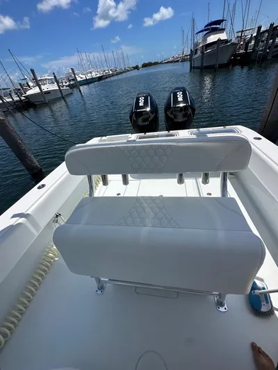  Yacht Photos Pics 2025 Contender 30 T boat with dual engines docked at a marina.