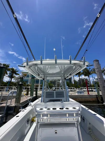  Yacht Photos Pics 2025 Contender 30 T boat docked under clear blue sky.
