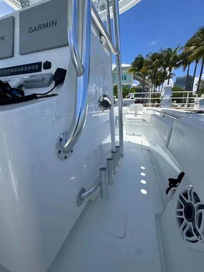  Yacht Photos Pics 2025 Contender 30 T boat deck with Garmin equipment, sleek design, and palm trees in the background.