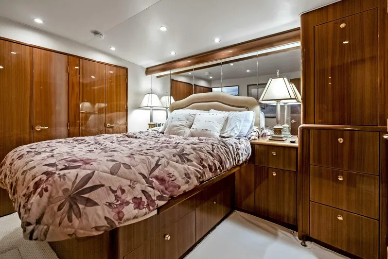 True Grit Yacht Photos Pics Luxurious bedroom in 2006 Viking 56 Convertible yacht with elegant wood furnishings.
