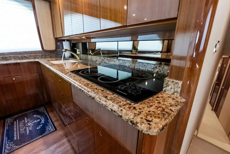 True Grit Yacht Photos Pics Luxurious kitchen in 2006 Viking 56 Convertible yacht with granite countertops and modern appliances.