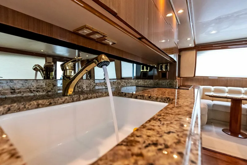 True Grit Yacht Photos Pics Luxurious kitchen interior of 2006 Viking 56 Convertible yacht with granite countertops.