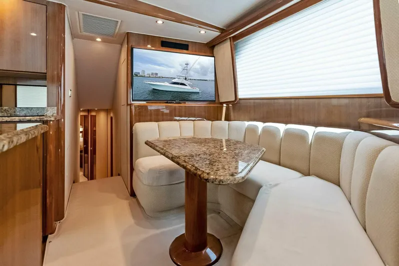 True Grit Yacht Photos Pics Luxurious interior of 2006 Viking 56 Convertible yacht with plush seating and TV.