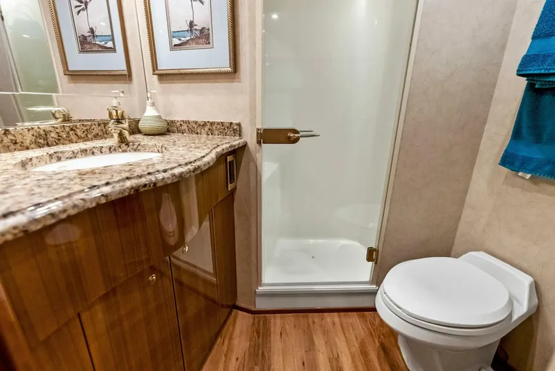 True Grit Yacht Photos Pics Luxurious bathroom in 2006 Viking 56 Convertible yacht with granite countertop and shower.