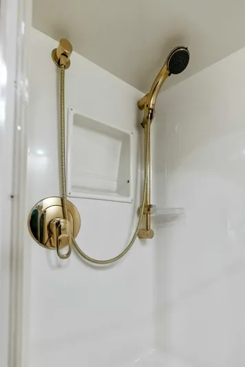 True Grit Yacht Photos Pics Gold shower fixtures in 2006 Viking 56 Convertible yacht bathroom.