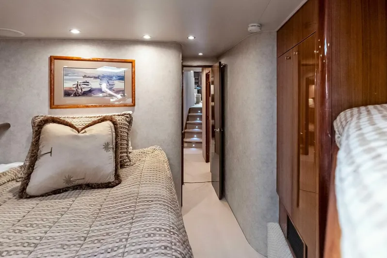 True Grit Yacht Photos Pics Interior of 2006 Viking 56 Convertible yacht bedroom with cozy bedding and artwork.