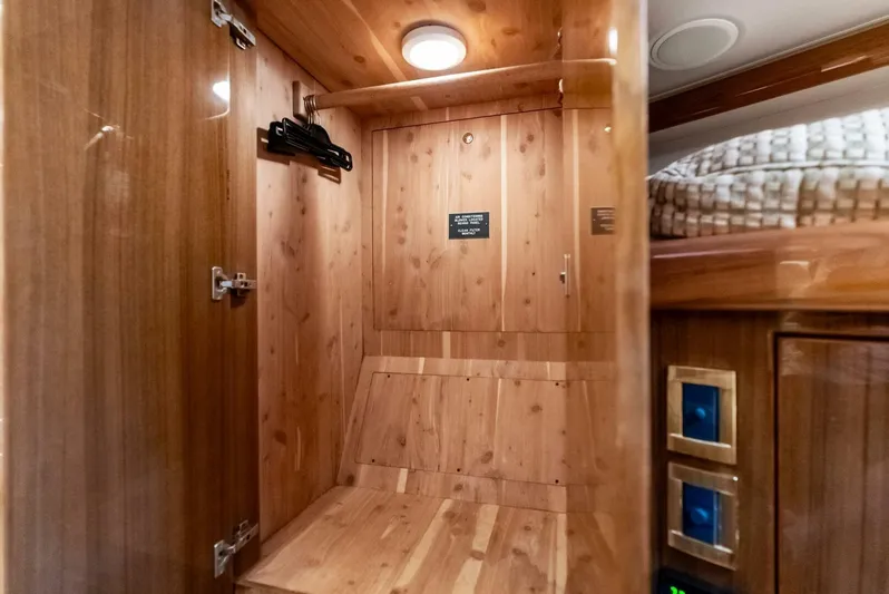 True Grit Yacht Photos Pics Wood-paneled interior of 2006 Viking 56 Convertible yacht, featuring a cozy cabin space.