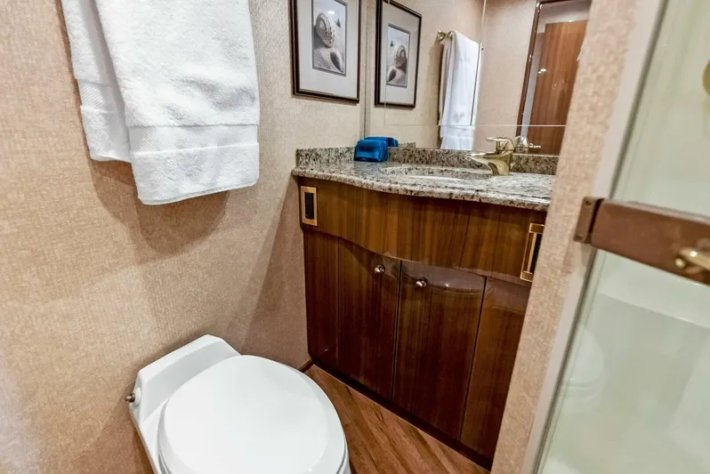 True Grit Yacht Photos Pics Luxurious bathroom in 2006 Viking 56 Convertible yacht with granite countertop and wood cabinetry.