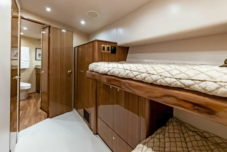 True Grit Yacht Photos Pics Interior of 2006 Viking 56 Convertible yacht with wooden bunk beds and bathroom.
