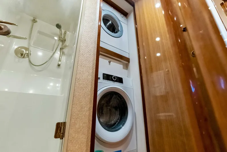 True Grit Yacht Photos Pics Laundry area with stacked washer and dryer in 2006 Viking 56 Convertible yacht.