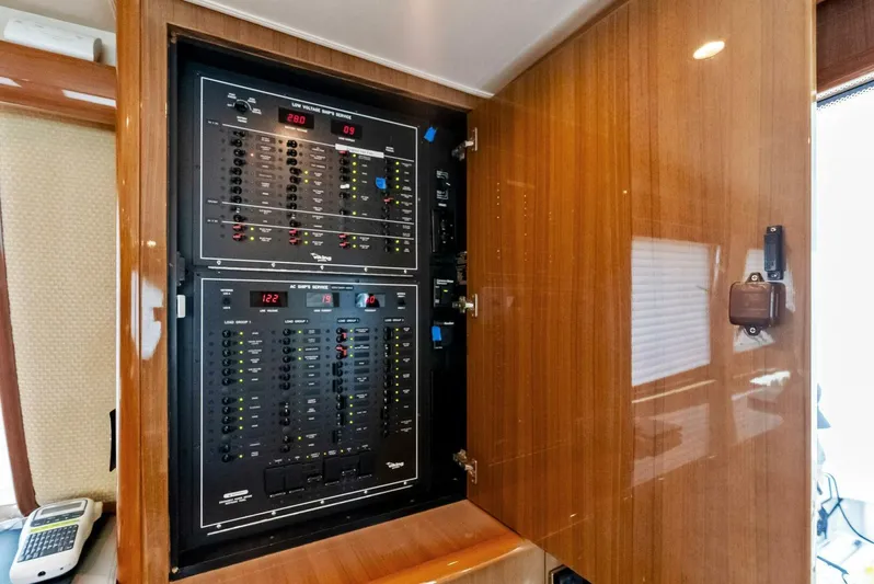 True Grit Yacht Photos Pics Electrical panel inside 2006 Viking 56 Convertible yacht with wooden interior.