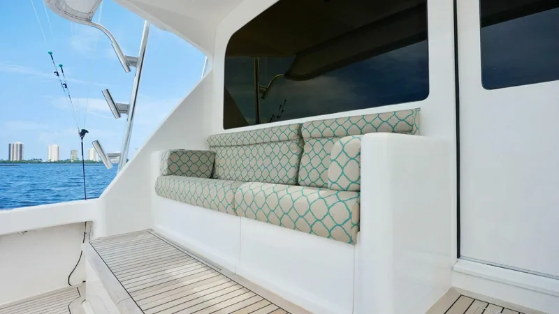 True Grit Yacht Photos Pics Viking 56 Convertible 2006 yacht with cushioned seating on deck, overlooking the ocean.