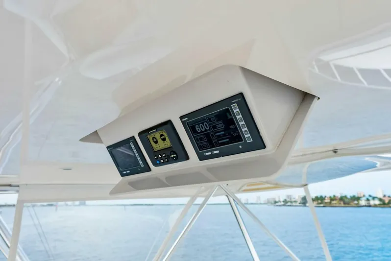 True Grit Yacht Photos Pics Viking 56 Convertible 2006 yacht dashboard with navigation displays, ocean view in background.