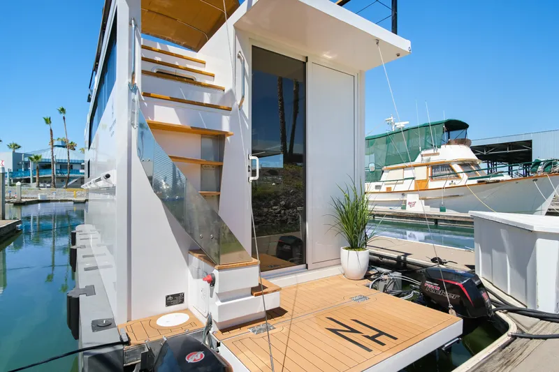 Yacht Photos Pics Modern 2024 Navisyo Homes 28' NAVIS V.08 houseboat docked with sleek design and outdoor stairs.