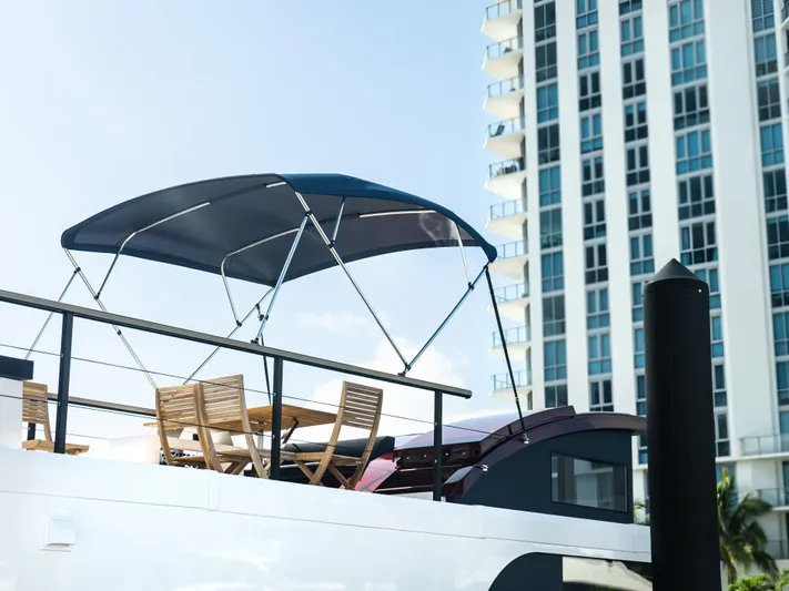  Yacht Photos Pics 2024 Navisyo Homes 28' NAVIS V.08 yacht with canopy and chairs, cityscape background.