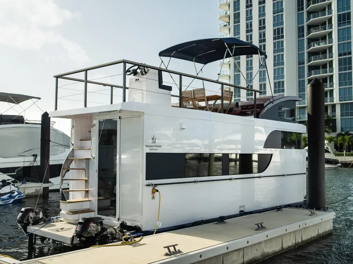  Yacht Photos Pics Modern 2024 Navisyo Homes 28' NAVIS V.08 houseboat docked by waterfront skyscrapers.