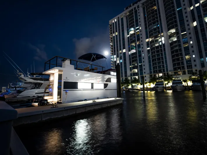  Yacht Photos Pics 2024 Navisyo Homes 28' NAVIS V.08 houseboat docked at night near illuminated buildings.