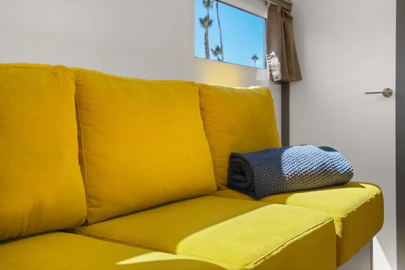  Yacht Photos Pics Bright yellow sofa in 2024 Navisyo Homes 28' NAVIS V.08 interior, with cozy blanket.