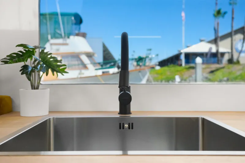  Yacht Photos Pics Modern kitchen sink with a sleek faucet, potted plant, and marina view on Navisyo Homes 28' NAVIS V.08.
