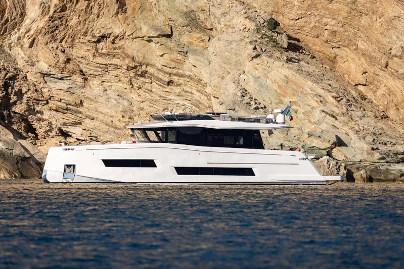  Yacht Photos Pics 2026 Pardo Yachts E72 luxury yacht cruising near rocky coastline.